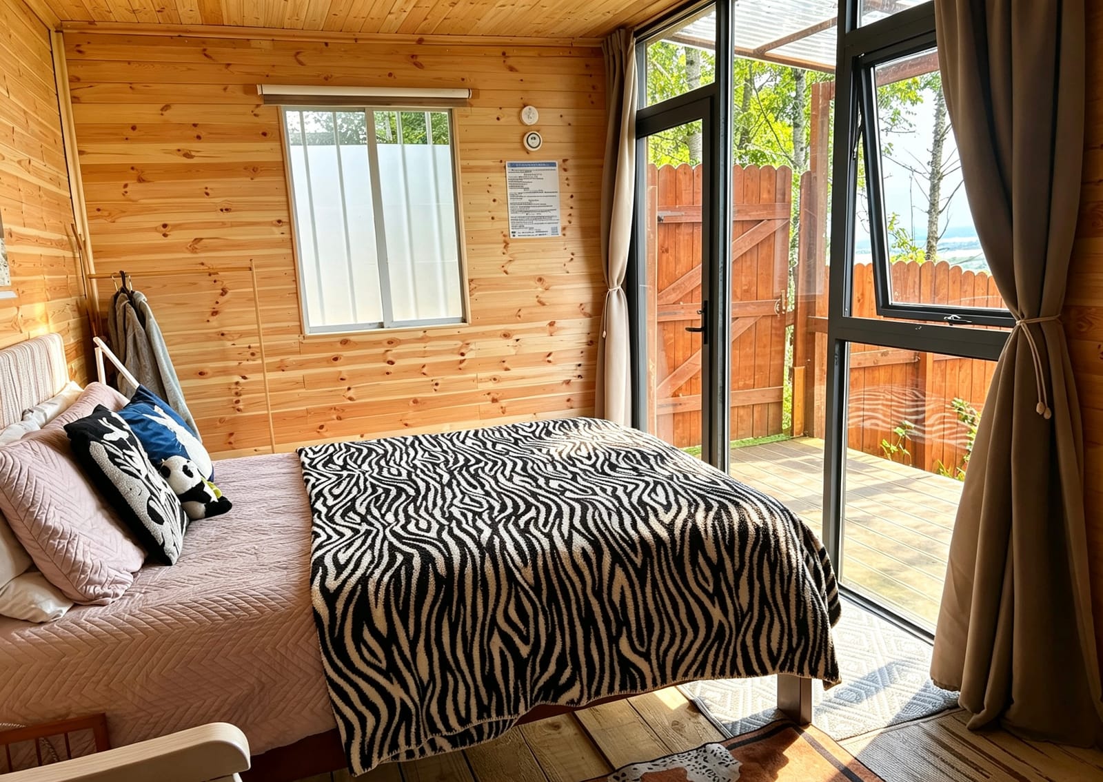 Cabin bed beside the glass garden doors